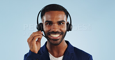 Buy stock photo Happy businessman, portrait and headphones for call center or telemarketing against a blue studio background. Face of male person, consultant or agent smile with mic for online advice on mockup space