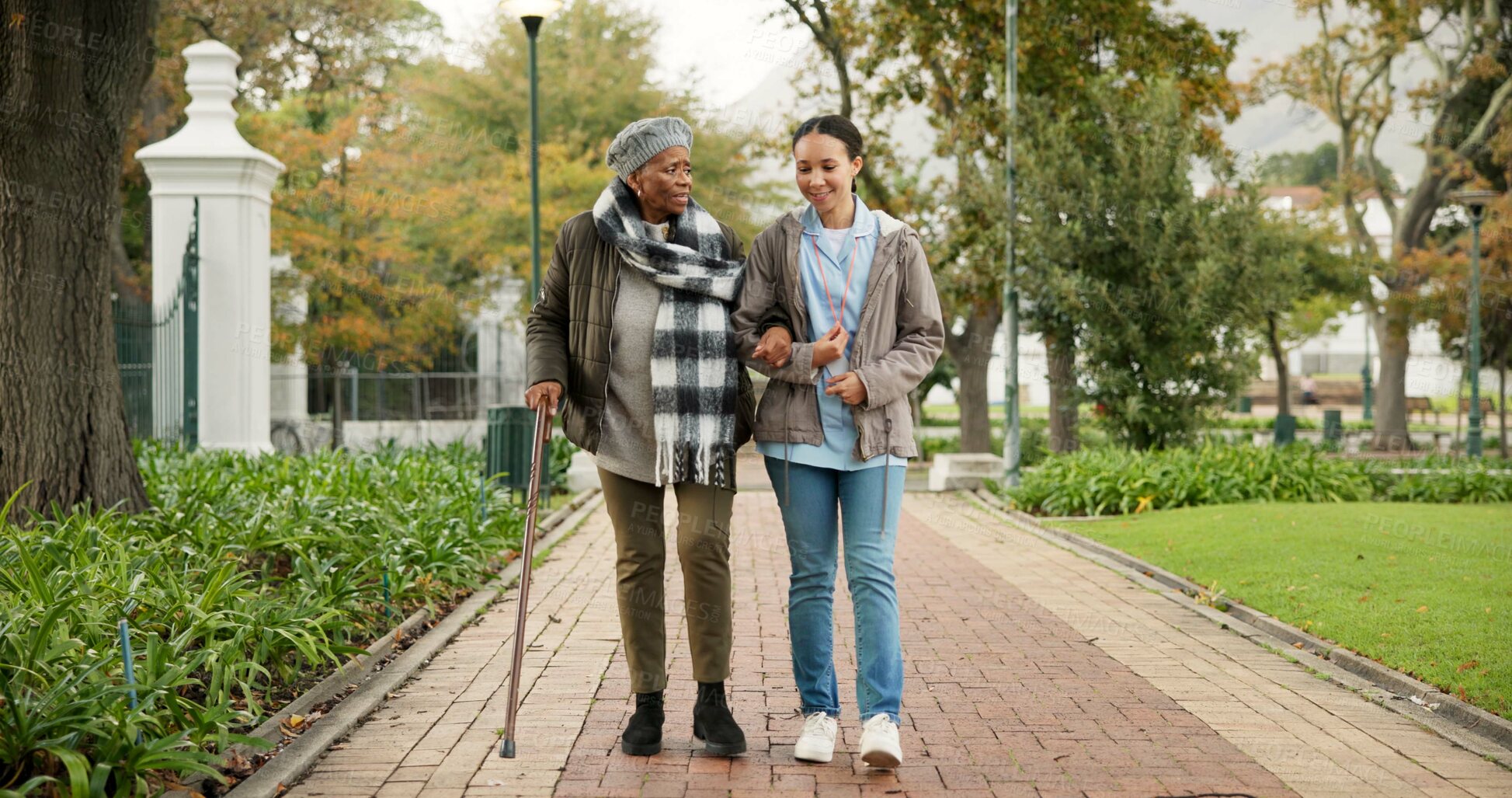 Buy stock photo Help, cane and nurse with old woman in park for relax, support and person with a disability. Elderly care, conversation and healthcare with caregiver and patient in nature for medical rehabilitation