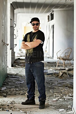 Buy stock photo A graffiti artist standing in front of a graffiti wall