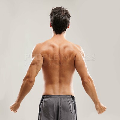Buy stock photo Rearview of a shirtless man stretching his back before a workout