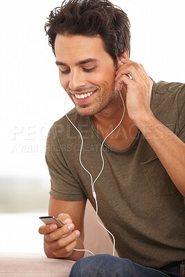 Buy stock photo Man, player or earphones or smile with music, podcast or radio streaming for break in living room of home. Person, face or listening and technology on couch in lounge for sound, song or audio track

