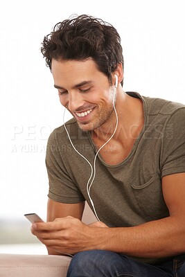 Buy stock photo Man, player and earphones or happy with music, podcast or radio streaming for break in living room of home. Person, face or listening and technology on couch in lounge for sound, song and audio track