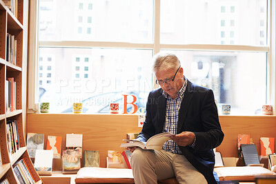 Buy stock photo Senior man, library and author reading book for literature, knowledge or story at bookstore. Mature male person or information by bookshelf for novel, learning or wisdom in shopping or leisure
