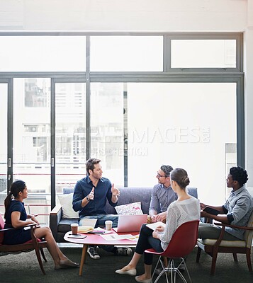 Buy stock photo Shot of a group of coworkers in a meeting in an office