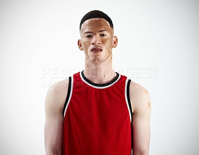 Buy stock photo Cropped portrait of a handsome young male basketball player posing in studio