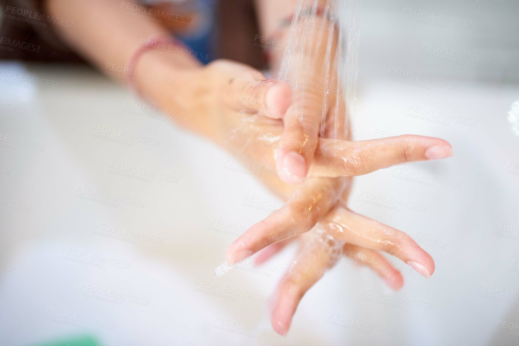 Buy stock photo Cropped shot of an unrecognizable woman washing her hands at home