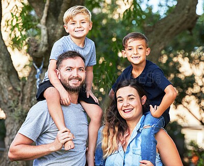 Buy stock photo Portrait of a beautiful family with their sons on their shoulders in a park