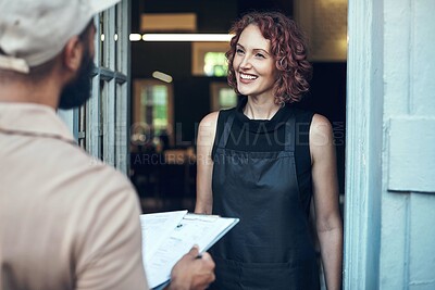 Buy stock photo Shot of an attractive young hairdresser receiving a delivery from the courier at her salon