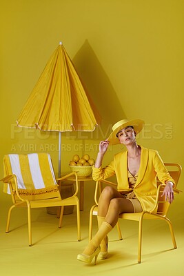 Buy stock photo Studio portrait of a young woman dressed in stylish yellow clothes against a yellow background