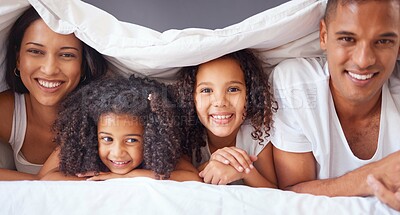 Buy stock photo Portrait of happy black family bonding on a bed, relax and smile in a bedroom together. Love, blanket and happiness parents enjoying free time with their children, being playful and love in morning
