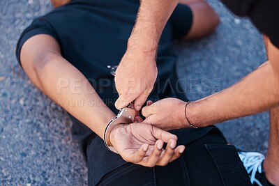 Buy stock photo Hands, handcuffs and man on floor with police agent, justice and human rights in Iran to stop protest. Crime, law and freedom in arrest in street, criminal or thief arrested in city by police officer