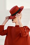 Woman, red hat and mystery with fashion, makeup and beauty with aesthetic, vintage style or character. Girl, model and retro clothes with cosmetics, art and hidden face with suit with creativity