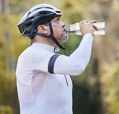 Buy stock photo Cycling, fitness and senior man drinking water in park for hydration during training exercise in nature. Bottle, thirsty and elderly athlete with electrolytes break or sports liquid in forest workout