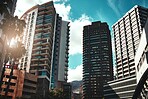 City, buildings and development with landscape for urban infrastructure or architecture outdoor in nature. Skyscraper, town and skyline with cityscape, tower and hotel with modern exterior or roof
