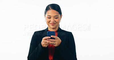 Buy stock photo Asian lawyer woman, phone and studio with smile, reading and texting client with news by white background. Japanese advocate, attorney or corporate legal expert with smartphone, typing and networking