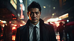 Asian man, night and mafia with city street, spy and mysterious in  rain. Serious, looking and rain with male wearing business suit for gangster, profit and asset for protective services and bodyguard