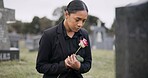 Sad woman, rose and graveyard in loss, grief or mourning at funeral, tombstone or cemetery. Female person with flower in depression, death or goodbye at memorial or burial service for loved one