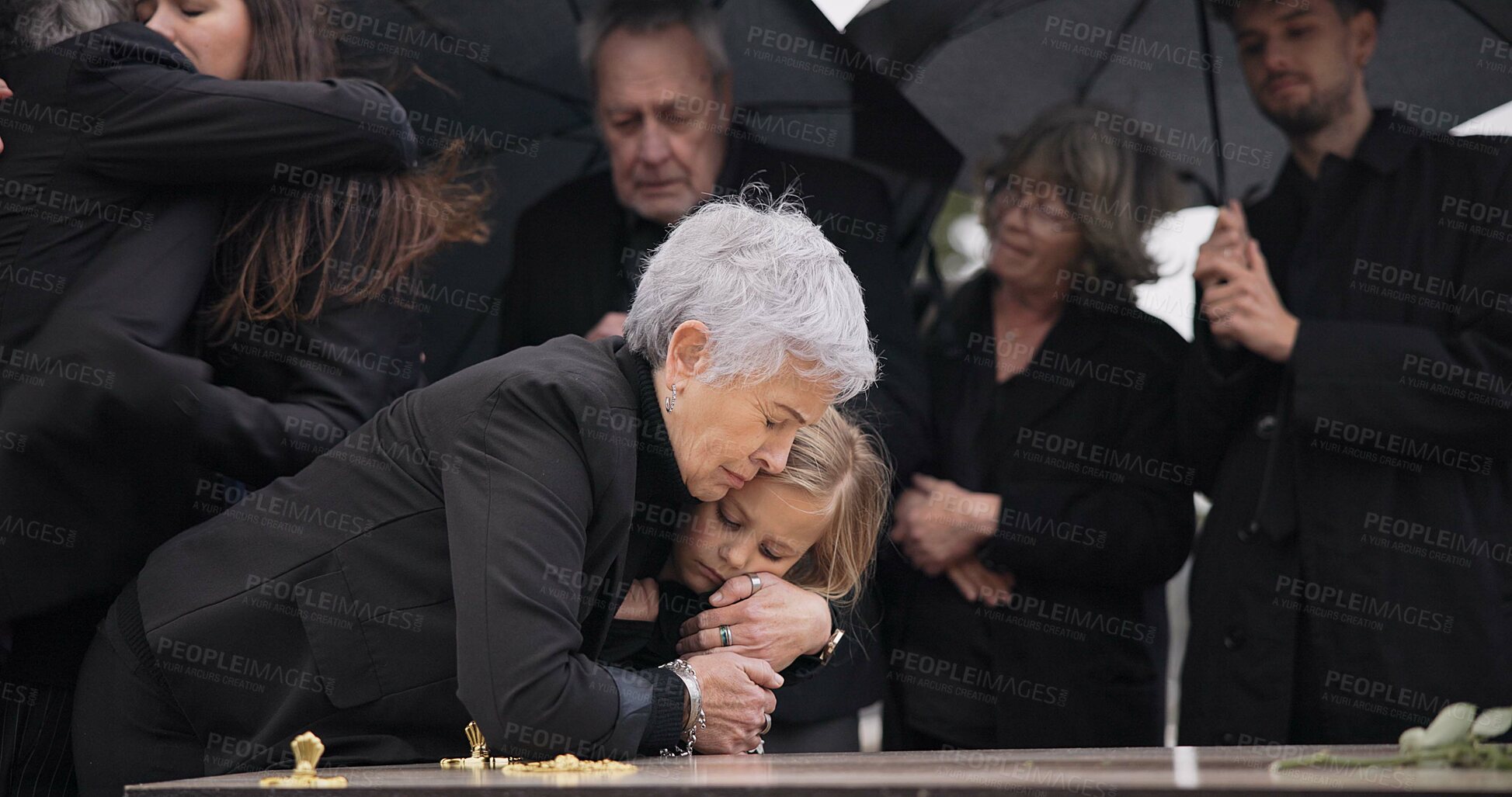 Buy stock photo Funeral, crying family and child hug grandmother for support, mourning depression and death at emotional burial event. Dead, love and kid hugging senior woman, grandma and grief at farewell ceremony