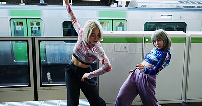 Buy stock photo Asian woman, dancing and street performance by railway station for energy or art in underground subway. Female person, friends or hip hop dancers in Japan, practice or training together by transport