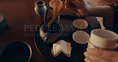 Hands of woman in traditional Japanese matcha, drink and relax with mindfulness, respect and service. Girl at calm tearoom with teapot, zen culture and ritual at table for tea ceremony from above.