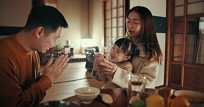 Buy stock photo Family, nutrition and dinner with girl, parents and Japanese with joy, meal and home with happiness. Mother, apartment and father with kid, food and bonding together with supper, smile and love