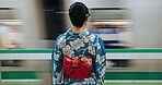 Japan woman, travel and train station in kimono and public transportation on metro bullet in city. Person, motion blur or traditional clothes by fast vehicle or subway in tokyo on urban adventure