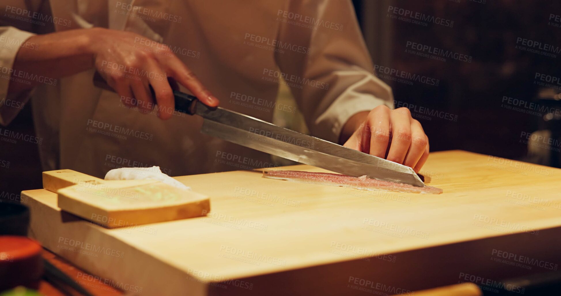 Buy stock photo Hands, food and chef cutting sushi in restaurant for traditional Japanese cuisine or dish closeup. Kitchen, cooking seafood for preparation and person working with gourmet meal recipe ingredients