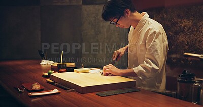 Buy stock photo Japan chef, restaurant and cutting fish for sushi, glasses and precision with knife for healthy food in kitchen. Asian man, hands and culinary artist on job by wood board, table and raw seafood menu