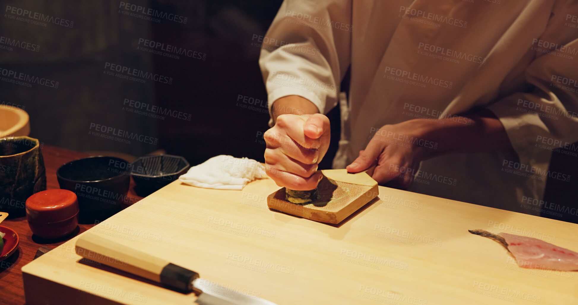 Buy stock photo Hands, food and wasabi with sushi chef in restaurant for traditional Japanese cuisine or dish closeup. Kitchen, seafood ingredients and preparation and person working with gourmet meal recipe