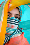 Muslim, portrait and woman wearing a traditional scarf or hijab for beauty fashion, modesty, and Islam. Confident, vibrant and beautiful shot of girl with colorful textile for awareness and hope