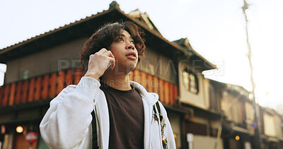 Buy stock photo Man, phonecall and outdoor in japan, lost and looking for directions in kyoto, standing and alone. Houses, japanese and cellphone for travelling, tourist and sightseeing and view with mobile