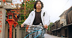 Bicycle, travel and man riding in the city for exercise or transportation to college academy. Fitness, backpack and young male student driving a bike to university for carbon footprint in urban town.