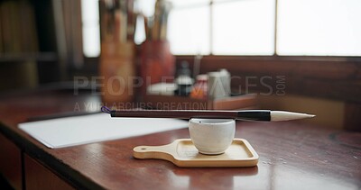 Buy stock photo Art, paint brush and tool for in room for painter, calligraphy and drawing at a desk for creative work. Sketch paper, sumi and home studio with ink pot, table and Japanese document for creativity 