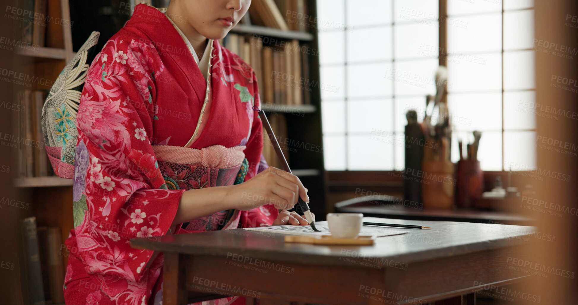 Buy stock photo Ink, writing and hands of Japanese woman for traditional script on paper, documents and page. Creative, Asian culture and person with vintage paintbrush tools for calligraphy, font and text in home