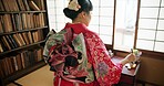 Window, writing and Japanese woman for traditional script on paper, documents and page in home. Creative, Asian culture and person with vintage paintbrush, ink and tools for calligraphy, font or text