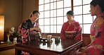 Japanese, women and matcha for tea ceremony in Chashitsu room with kimono dress and traditional custom. People, temae and vintage style outfit for culture, fashion and honor with antique crockery 