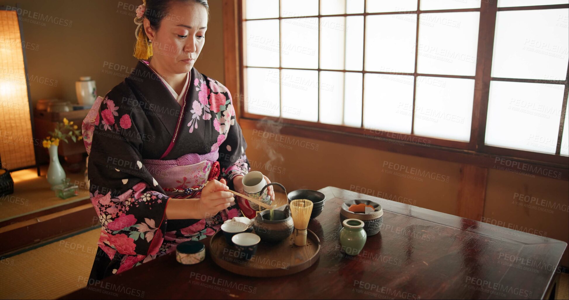 Buy stock photo Japanese, woman and kimono for tea ceremony in Chashitsu room with matcha and traditional custom. Person, temae and vintage style outfit or dress for culture, fashion and honor with antique crockery 