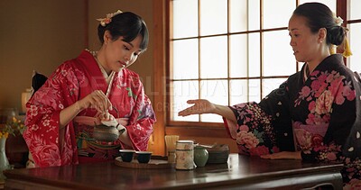 Buy stock photo Traditional, ceremony and Japanese women with tea in home with herbs, leaves and flavor in teapot. Ritual, indigenous and people with herbal beverage for culture, talking and wellness for drinking