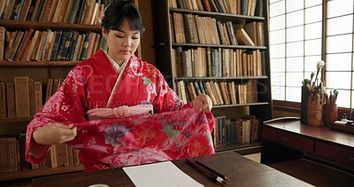 Buy stock photo Woman, art and Japanese painting tool in a living room with traditional culture, home and dress. Zen, Tokyo and calm with indigenous ritual, drawing and paper for creativity with document and silk