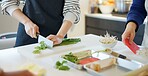 Chef hands, knife and spring onion for cooking, chopping and prepare ingredients for catering services. Person, cutting vegetables and food for diet, nutrition and fine dining at restaurant in Tokyo