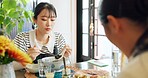 Japanese woman, eating and food in restaurant, chopsticks and hungry with plate for nutrition. Girl, people and bowl for health, wellness and diet with choice at cafeteria, diner and brunch in Tokyo