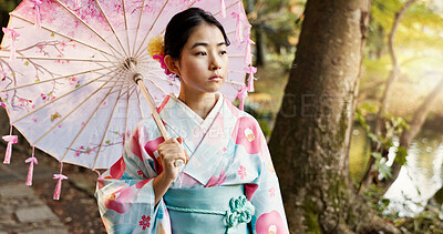 Buy stock photo Umbrella, traditional and Japanese woman in park for wellness, fresh air and thinking outdoors. Travel, culture and person in indigenous clothes, style and kimono for zen, peace and calm in nature