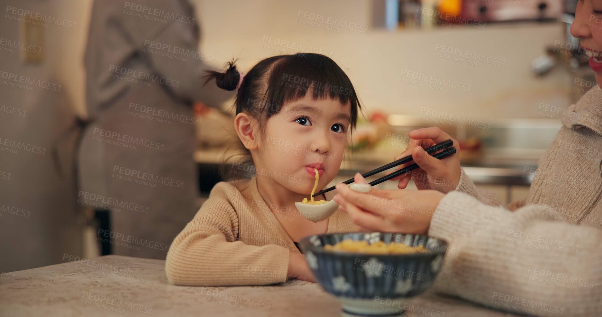 Buy stock photo Family, japanese and woman feeding daughter in kitchen of home for growth, health or nutrition. Food, girl eating in Tokyo apartment with mother and grandparent for diet or child development