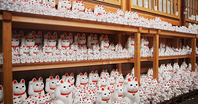 Buy stock photo Japan, traditional and neko maneki or group in shop for good luck cat, fortune or culture. Sculpture figure, gotokuji and store for travel destination in Tokyo for local history, spiritual or gift