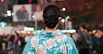 Travel, city and Japanese woman in kimono on street with crowd for culture, heritage or tradition. Back, fashion and person walking outdoor on street of urban Tokyo town for vacation or sightseeing