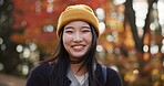Woman, forest and portrait in Kyoto, garden and tourist with happiness, traditional history and travel. Nature, japanese culture and explore in woods with trees, adventure and holiday walk in autumn