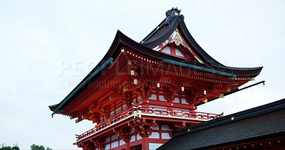 Architecture, building and shinto temple for religion, travel and traditional landmark for spirituality. Buddhism, Japanese culture and trip to Kyoto, zen and pray in landscape by sky background