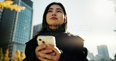 Buy stock photo Walking, cellphone and Japanese woman in the city networking on social media or the internet. Phone, adventure and young female person commuting for travel in road of urban town in Kyoto Japan.