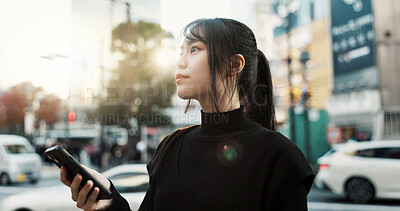 Buy stock photo Walking, cellphone and Japanese woman in the city networking on social media or the internet. Phone, adventure and young female person commuting for travel in road of urban town in Kyoto Japan.