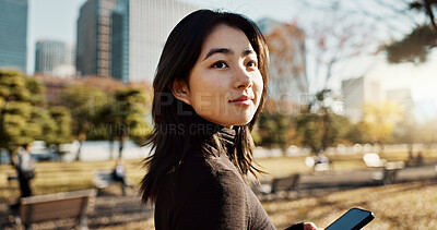 Buy stock photo Japanese, woman and using phone in park, travel and communication with social media and adventure. Texting, email and online chat with connectivity, mobile app and outdoor for fresh air in Tokyo